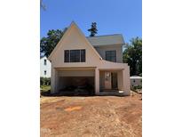 New construction exterior featuring white brick, an attached two-car garage, and a modern architectural style at 1002 Canterbury Rd, Raleigh, NC 27607