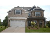 Two-story home featuring a stone and brick exterior with a two-car garage and well-manicured lawn at 1055 Tulloch Ct # 202, Burlington, NC 27215