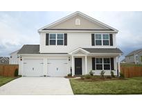 Charming two-story home featuring a two-car garage, black shutters, and a well-manicured lawn at 1061 Thicket Dr # 356, Burlington, NC 27217