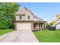 Charming two-story home features a two-car garage and manicured front lawn at 124 Owensboro Ct, Raleigh, NC 27603