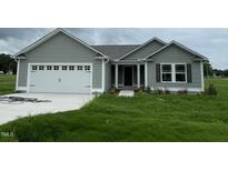 Charming single-Gathering home with gray siding, a two-car garage, and a well-maintained lawn at 167 Lotus Ave, Smithfield, NC 27577