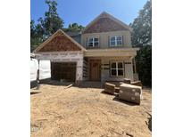 New construction home featuring a two-car garage, covered front porch, and wood and light-green siding at 188 Landon Ridge, Sanford, NC 27330