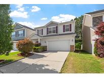 Charming two-story home with a two-car garage and well-maintained landscaping at 208 Station Dr, Morrisville, NC 27560