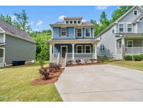 Charming two-story home with a welcoming front porch and well-maintained landscaping at 2407 Miriam Cir, Durham, NC 27704