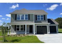 Charming two-story home with a manicured lawn, black shutters and a two-car garage at 253 Lotus Ave, Smithfield, NC 27577