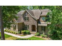 Stunning stone home with manicured lawn and meticulously maintained landscaping at 304 Villa Dr, Durham, NC 27712