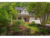 Charming two-story home with manicured landscaping, inviting front porch, and attached two car garage at 401 Robert Hunt Dr, Carrboro, NC 27510