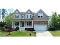 Charming two-story home featuring a welcoming front porch, beautiful landscaping, and a two-car garage at 704 Valleywater St, Fuquay Varina, NC 27526