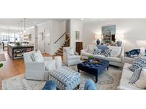 Bright and airy living room features stylish seating, area rug, and decor in a modern design at 810 Maple Berry Ln # 104, Raleigh, NC 27607