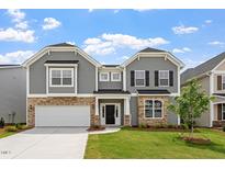 Charming two-story home featuring stone accents, gray siding and a well-manicured lawn at 95 Black Walnut Dr # 191, Garner, NC 27529