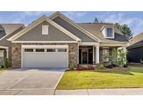 Charming home featuring stone accents, well-manicured lawn, and attached two car garage at 1009 Middleground Cir, Durham, NC 27713