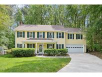 Charming two-story home with a well-manicured lawn and attached two-car garage at 106 Shady Point Ct, Durham, NC 27713
