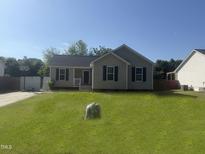 Charming single-story home with blue shutters and a well-maintained lawn at 118 Hawthorn Dr, Clayton, NC 27520