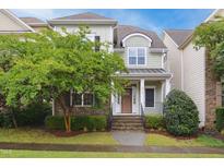 Charming two-story home featuring stone accents, a cozy porch, and lush landscaping in a desirable neighborhood at 1212 Sand Pine Dr, Cary, NC 27519