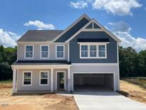 Charming two-story home featuring a spacious garage and classic architectural details at 129 Sagamore Avenue, Angier, NC 27501