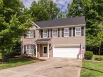Charming two-story home with brick and vinyl siding and an attached two-car garage at 1307 Montreux Ct, Mebane, NC 27302