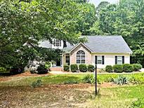 Charming single-Gathering home with beautiful landscaping and mature trees surrounding the property at 146 Bennett Pl, Clayton, NC 27527