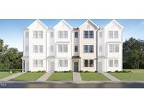 New townhome construction with classic architectural details and manicured lawn at 1538 Crescent Townes Way, Raleigh, NC 27604