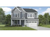 Charming gray two-story home with stone accents, complemented by a well-manicured lawn and a two-car garage at 1601 Goldfinch Perch Ln, Knightdale, NC 27545