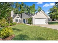 Charming home featuring a well-manicured lawn and a two-car garage at 205 Hornholly Way, Holly Springs, NC 27540