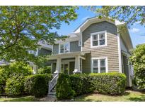 Charming two-story home featuring a shake shingle exterior, white trim, and a well-manicured landscaped front yard at 2121 Karns Pl, Raleigh, NC 27614