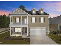 Charming two-story home with a covered front porch and a two-car garage at 2501 Macedonia Pine Dr, Raleigh, NC 27616