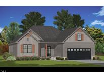 Charming single-story home featuring a gray facade, wooden shutters, and a two-car garage, all set against a backdrop of lush greenery at 260 Pilot Ridge Rd, Zebulon, NC 27597