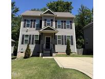 Charming two-story home features a well-manicured lawn and classic black shutters, creating inviting curb appeal at 317 Chamberlain Dr, Clayton, NC 27527