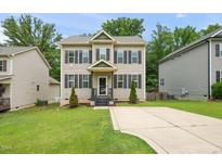Charming two-story home with a well-maintained lawn and inviting curb appeal at 317 Chamberlain Dr, Clayton, NC 27527