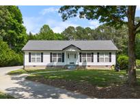 Charming single-story home with a well-manicured lawn and inviting front porch at 4022 Avents Ferry Rd, Sanford, NC 27330