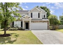 Charming two-story home with stone accents, a well-maintained lawn, and a spacious two-car garage at 430 Dogwood Creek Pl, Fuquay Varina, NC 27526