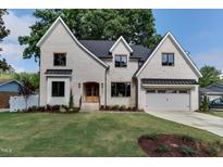Charming, two-story brick home with a well-manicured lawn and inviting curb appeal at 4921 Sweetbriar Dr, Raleigh, NC 27609