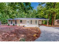 Charming ranch-style home with a well-manicured lawn and covered front entrance, perfect for outdoor living at 9614 Quail Roost Rd, Bahama, NC 27503