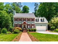 Charming two-story home featuring a brick walkway and well-maintained landscaping at 105 Juniper Ct, Carrboro, NC 27510