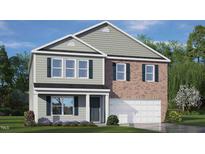 Charming two-story home featuring brick and siding exterior, complemented by lush landscaping and a welcoming two car garage at 108 Reagan Crest Dr, Clayton, NC 27520
