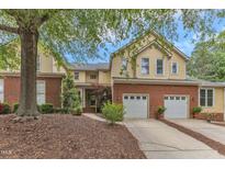 Charming two-story home featuring a brick foundation and attached two-car garage at 11035 Southwalk Ln, Raleigh, NC 27614
