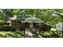 Charming brick home with a well-maintained front yard and inviting covered porch at 1223 Wallace St, Burlington, NC 27215