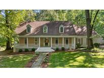 Charming home with a welcoming front porch and beautiful landscaping at 191 Nc 56, Louisburg, NC 27549