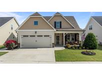 Charming single-Gathering home featuring a two-car garage, covered porch, and beautifully landscaped front yard at 24 Sweet Birch Row, Youngsville, NC 27596
