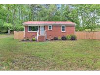 Charming brick home with a bright red roof and well-manicured lawn at 774 Salem Church Rd, Sanford, NC 27330