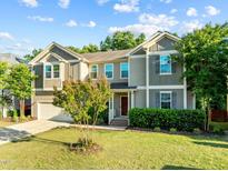 Charming two-story home with manicured lawn and beautiful landscaping at 109 Highland Mist Cir, Apex, NC 27539