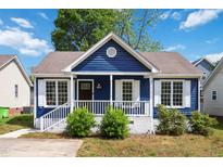 Charming blue home featuring a cozy front porch and white trim details at 1508 Malta Ave, Raleigh, NC 27610