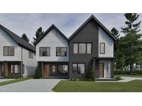 Modern two-story home boasts a combination of gray brick and white siding and a well manicured lawn at 1802 Pershing Rd, Raleigh, NC 27608