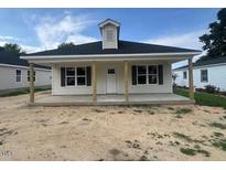 Charming single-story home with a welcoming porch, perfect for relaxing outdoors at 229 E Washington St, Coats, NC 27521