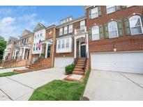 Charming townhomes featuring brick facades, manicured lawns and two-car garages at 2506 Blooming St, Raleigh, NC 27612