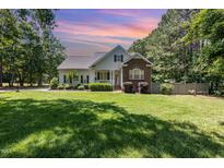 Charming two-story home with a well-maintained lawn and complemented by mature trees at 2833 Praire View Pt, Wendell, NC 27591