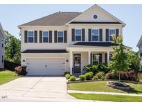 Charming two-story home with a well-manicured lawn and a two-car garage at 2909 Thurman Dairy Loop, Wake Forest, NC 27587
