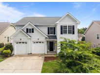Charming two-story home with a two-car garage and nicely landscaped front yard under a bright sky at 333 Trout Valley Rd, Wake Forest, NC 27587