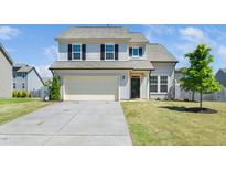 Charming two-story home featuring a spacious two car garage and a well-manicured front lawn at 51 Duchess Ave, Franklinton, NC 27525