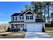 Two-story home with gray siding, black shutters, and a two-car garage at 79 Butterbean Ct, Zebulon, NC 27597